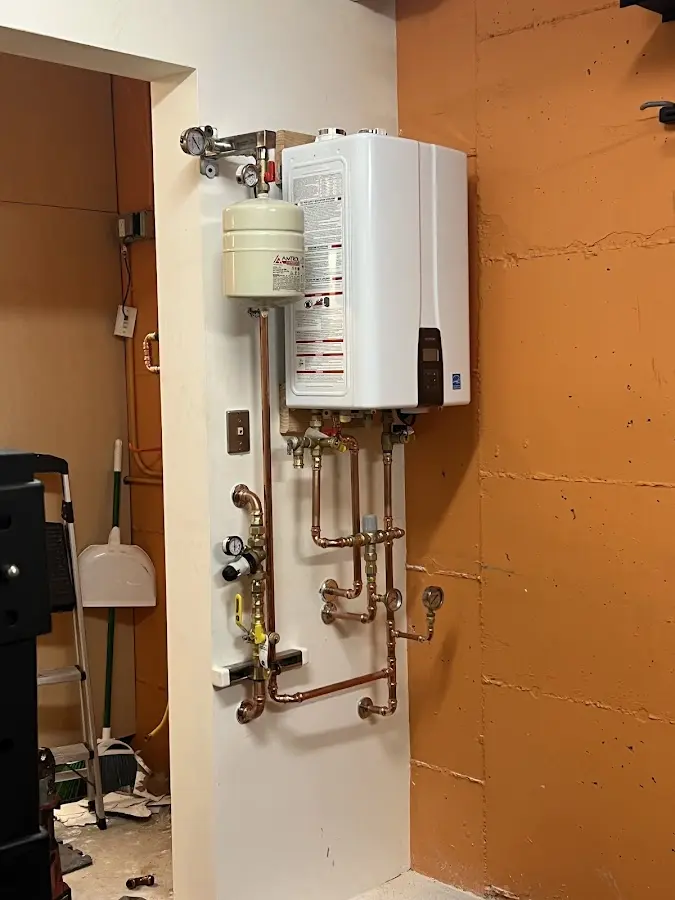 Plumbing technician inspecting water heater connections in Moorestown
